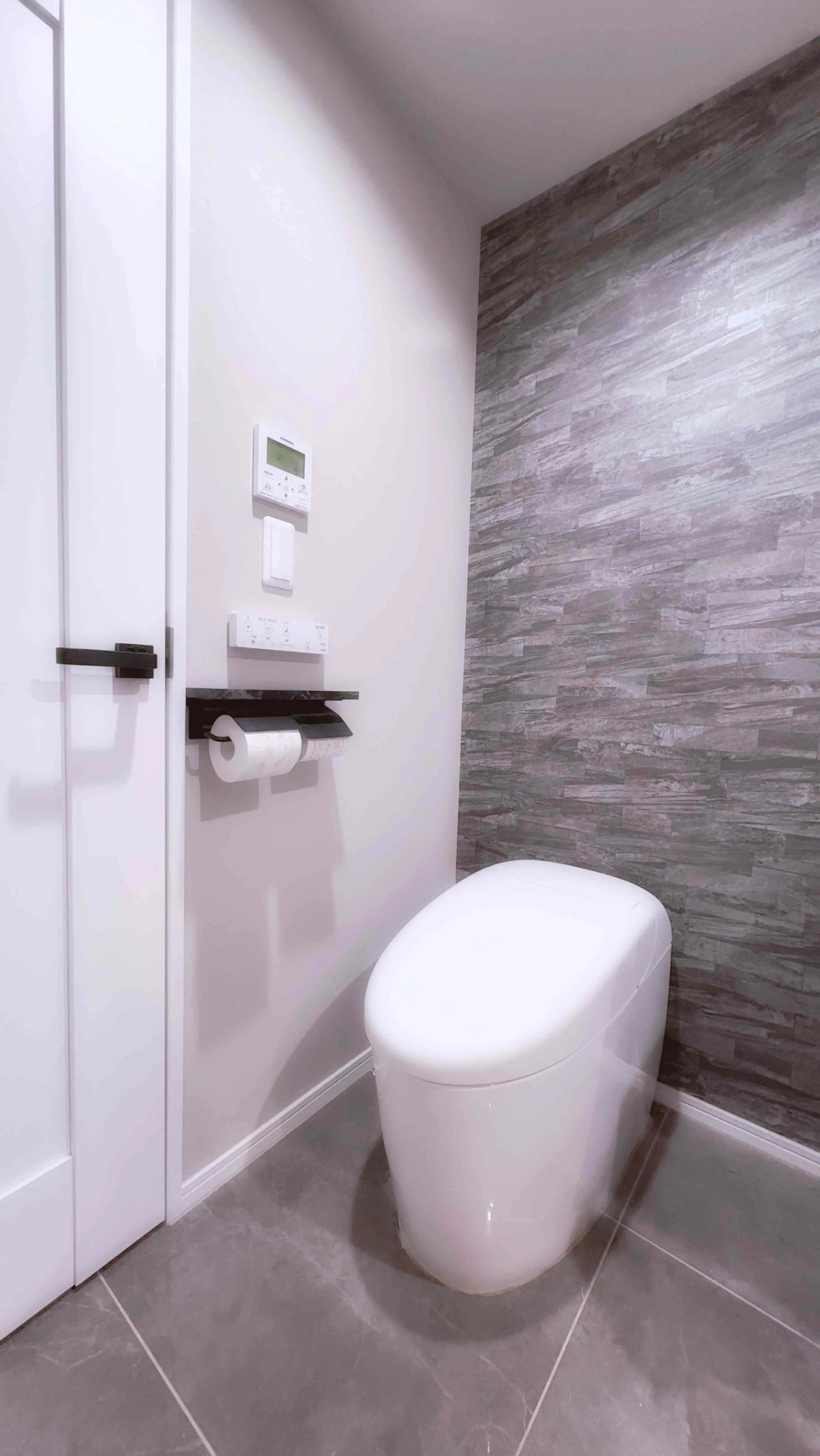 Modern washlet toilet in a tiled powder room.